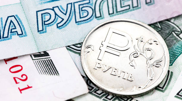 closeup macro one russian ruble metal coin and 1000 thousand rubles banknotes stock photo