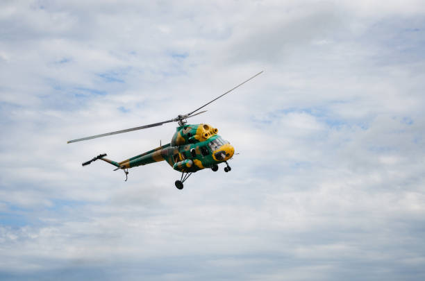 istock Khaki colored helicopter is flying in sky 1167632256