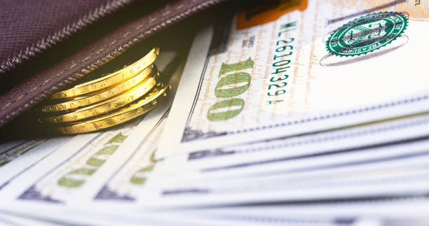istock closeup stack metal coins, hundred dollars in wallet 1167634361