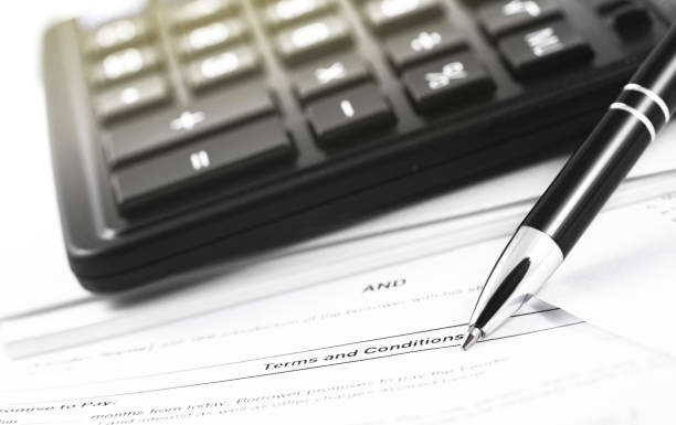 istock finance concept in paperwork, black calculator and pen closeup 1167634389
