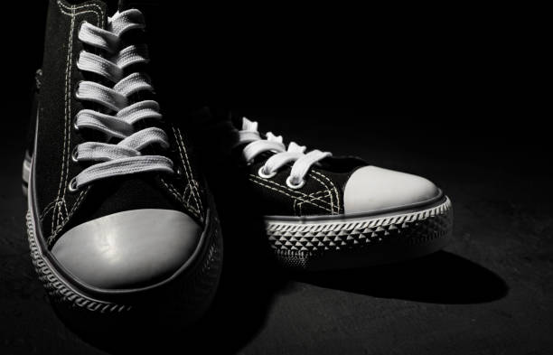 istock new black sneakers on dark black background with copy space. 1167636800