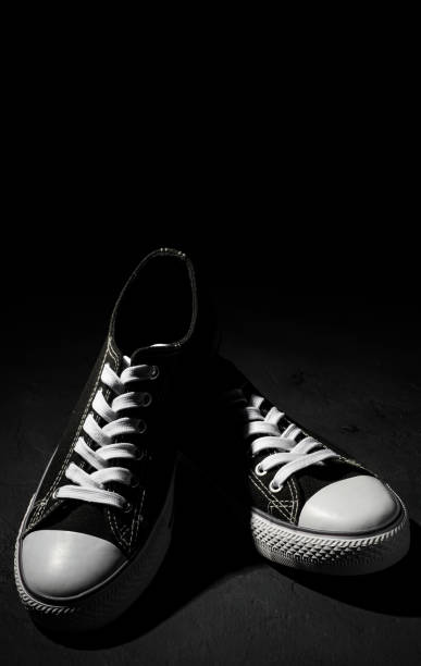 istock new black sneakers on dark black background with copy space. 1167636803