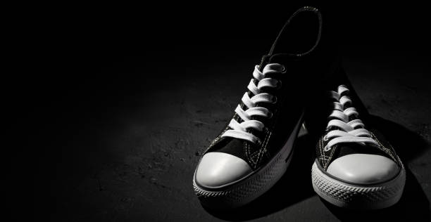 istock new black sneakers on dark black background with copy space. 1167636851