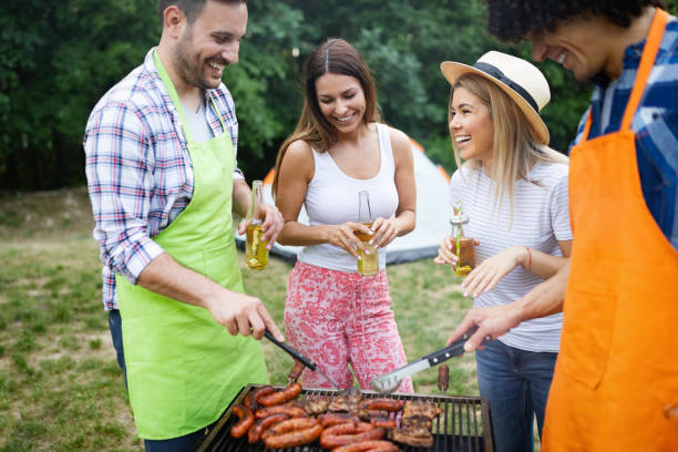 istock Happy friends camping and having a barbecue in nature 1167638383