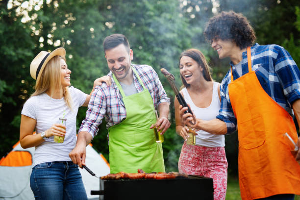 istock Happy friends camping and having a barbecue in nature 1167638558