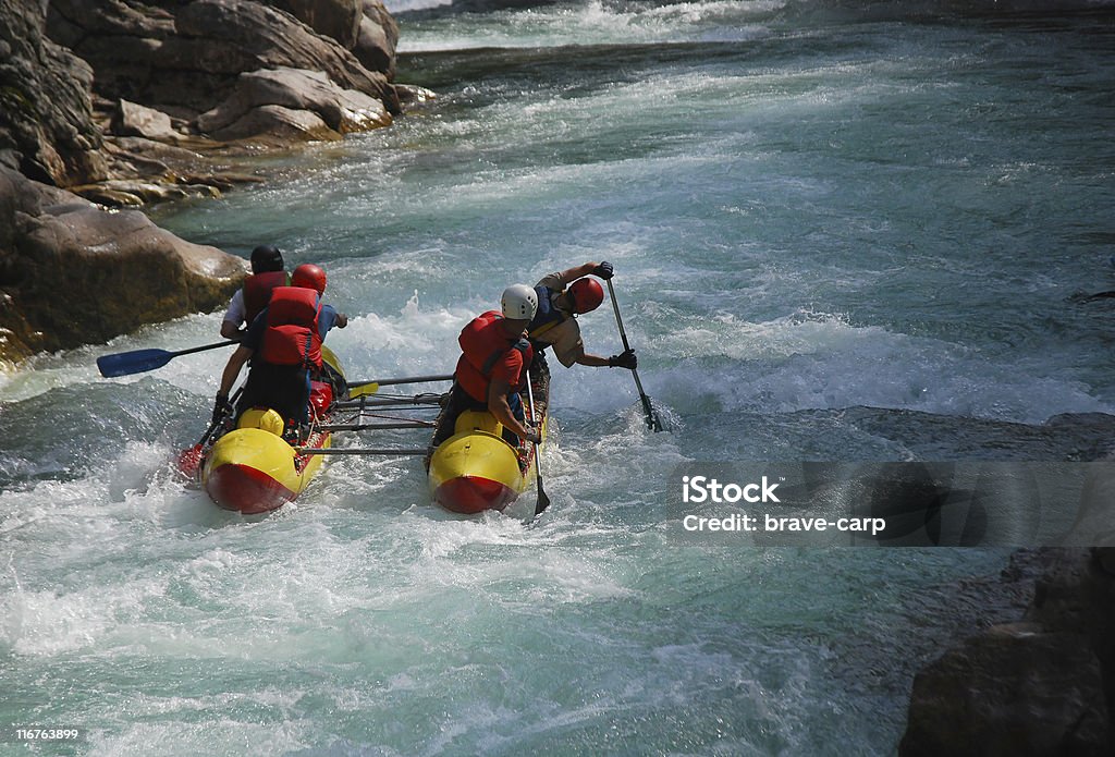 Aggressive water Four sportsmen float on the dangerous mountain river. Catamaran Stock Photo