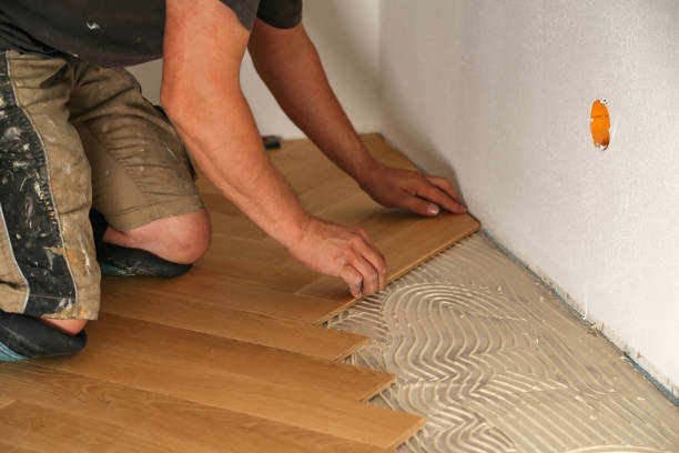 istock Worker laying parquet flooring. Worker installing wooden laminate flooring 1167643726