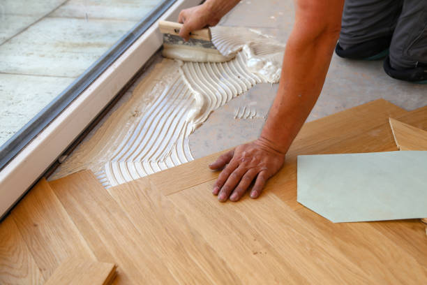 istock Worker laying parquet flooring. Worker installing wooden laminate flooring 1167643860