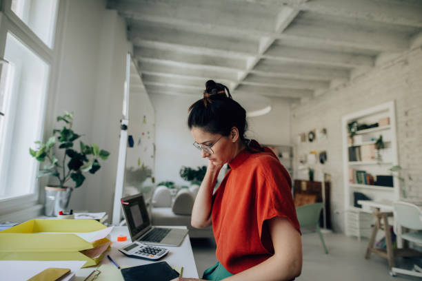 istock Young woman working in a modern office 1167643887