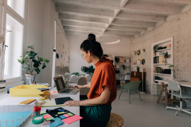 istock Young woman working in a modern office 1167643888