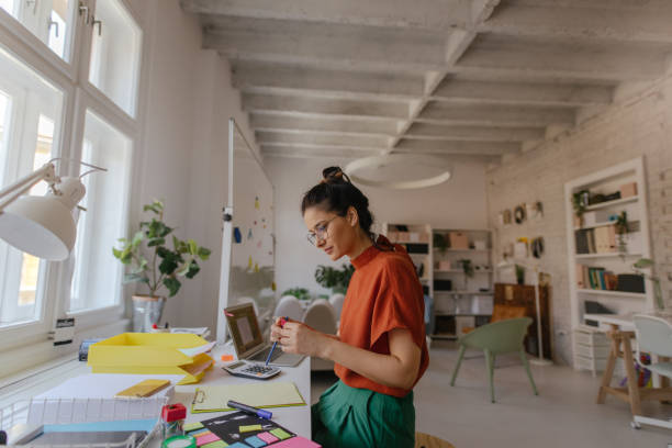 istock Young woman working in a modern office 1167643890