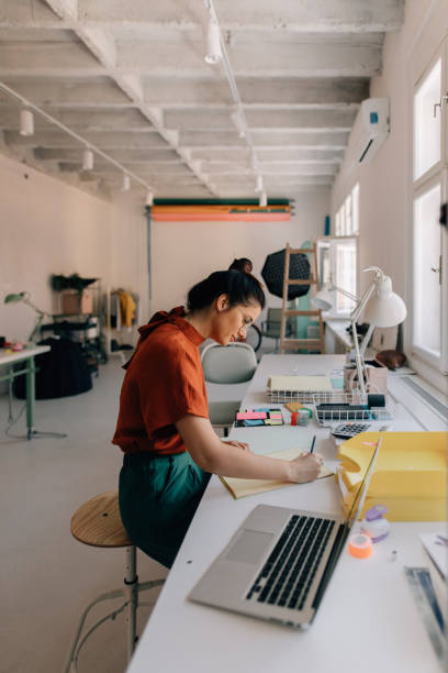 istock Young woman working in a modern office 1167643905