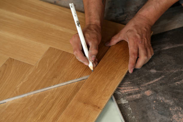 istock Worker laying parquet flooring. Worker installing wooden laminate flooring 1167643915