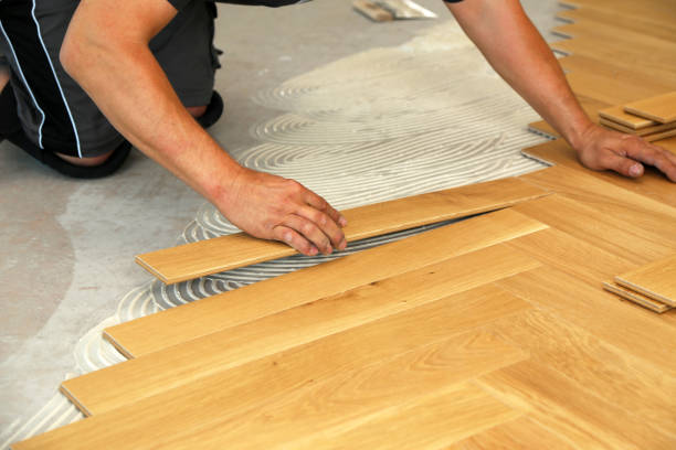 istock Worker laying parquet flooring. Worker installing wooden laminate flooring 1167644065