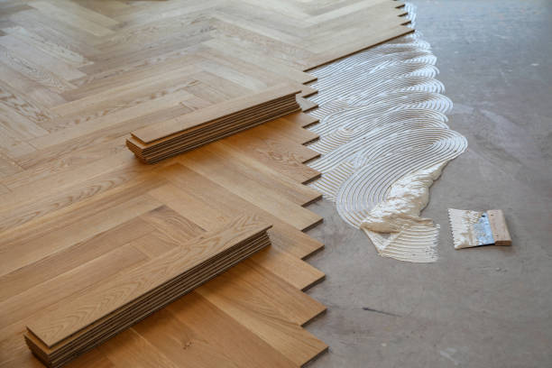istock Worker laying parquet flooring. Worker installing wooden laminate flooring 1167644101