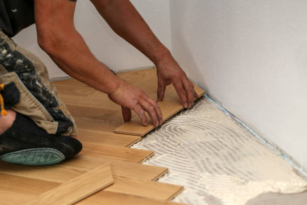 istock Worker laying parquet flooring. Worker installing wooden laminate flooring 1167644118