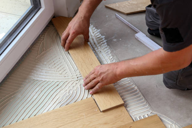 istock Worker laying parquet flooring. Worker installing wooden laminate flooring 1167644125