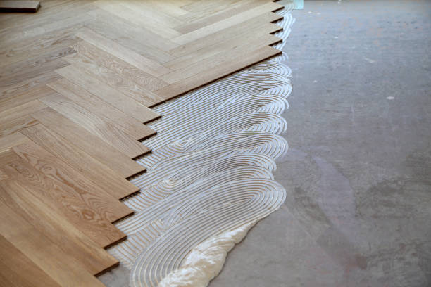 istock Worker laying parquet flooring. Worker installing wooden laminate flooring 1167644162