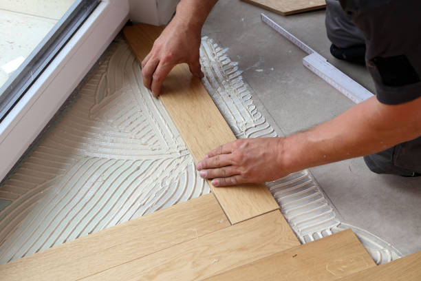 istock Worker laying parquet flooring. Worker installing wooden laminate flooring 1167644182