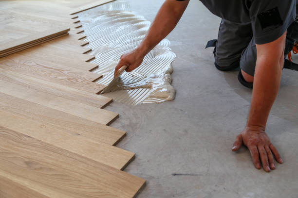 istock Worker laying parquet flooring. Worker installing wooden laminate flooring 1167644208