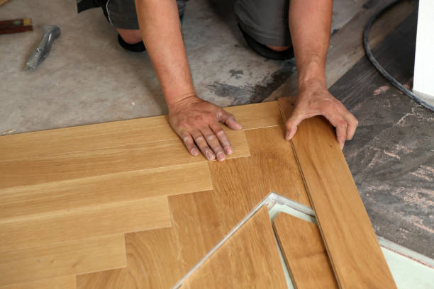 istock Worker laying parquet flooring. Worker installing wooden laminate flooring 1167644219