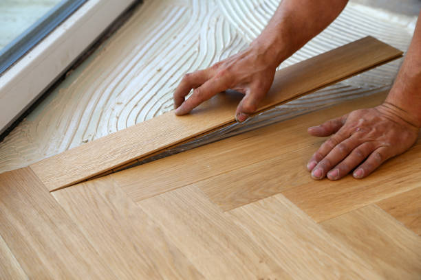 istock Worker laying parquet flooring. Worker installing wooden laminate flooring 1167644252