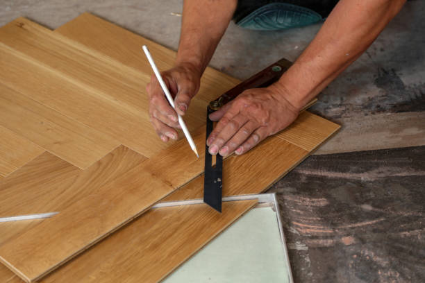 istock Worker laying parquet flooring. Worker installing wooden laminate flooring 1167644309