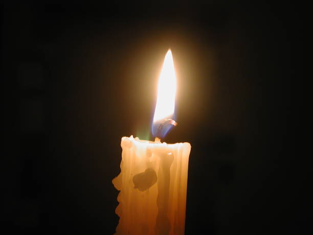 istock a candle burning in the dark 1167644314