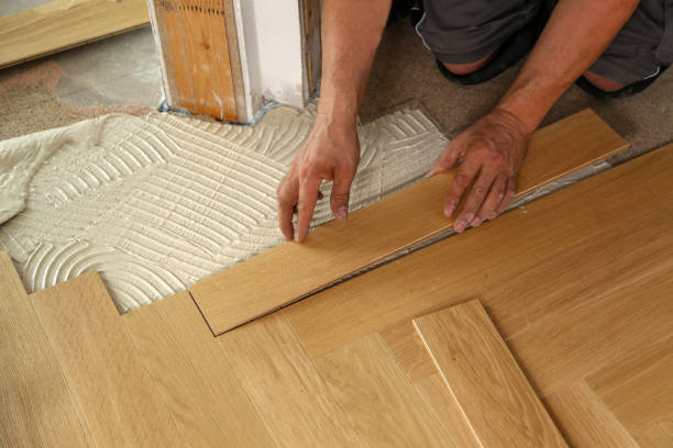 istock Worker laying parquet flooring. Worker installing wooden laminate flooring 1167644342
