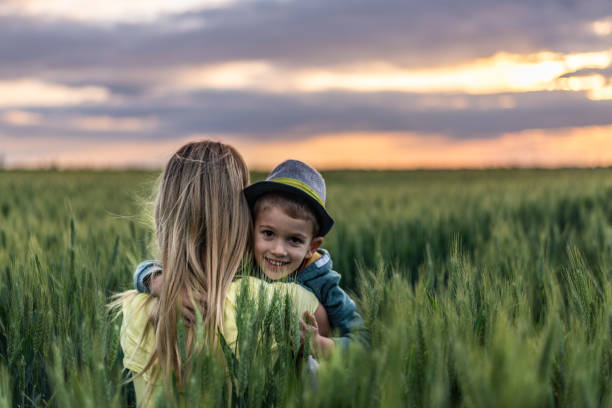 istock Mother and her son sharing love in nature on a sunset 1167644636