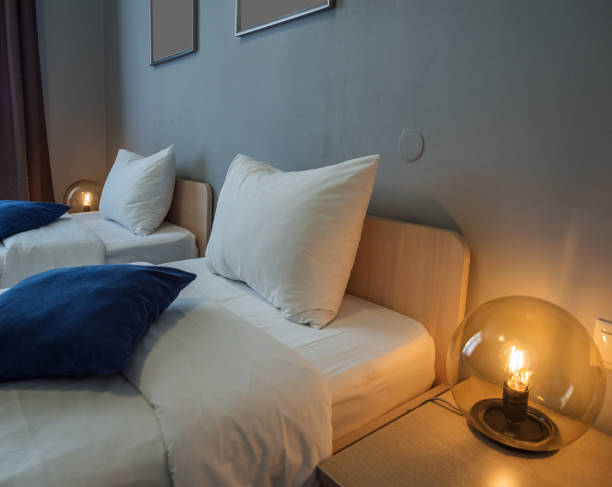 istock A beautiful round lamp shines near bedside table 1167646192
