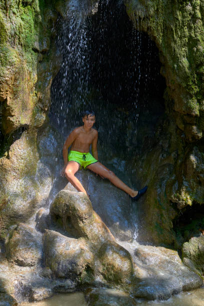 istock Boy under a Krka waterfalls in Croatia . Europe 1167652965