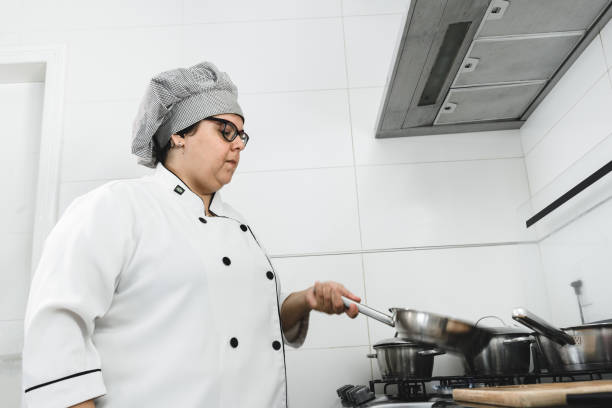 istock Woman chef working on the stove 1167653351