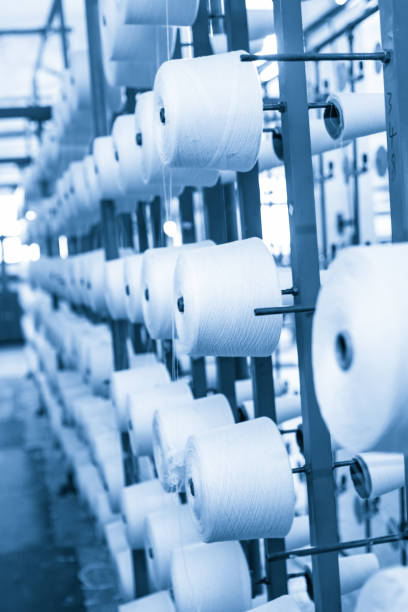 istock spindle with white yarn in the jean factory 1167655415