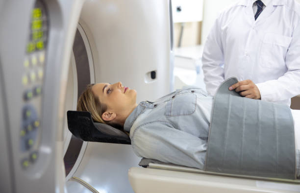 istock Doctor preparing young lady for CT scan 1167655720