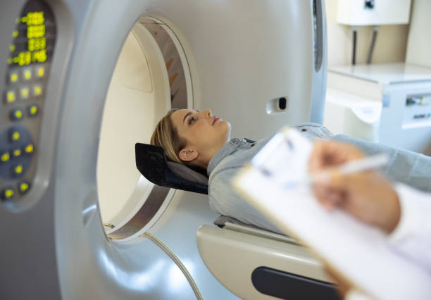 istock Young woman lying on CT machine table at radiology clinic 1167655723