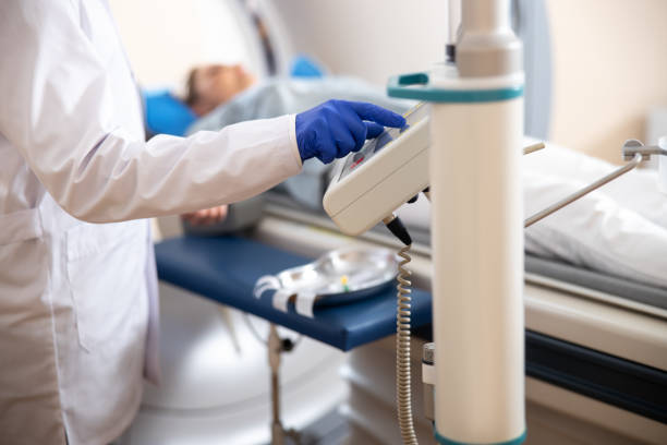 istock Doctor in sterile gloves using CT scanner 1167655748