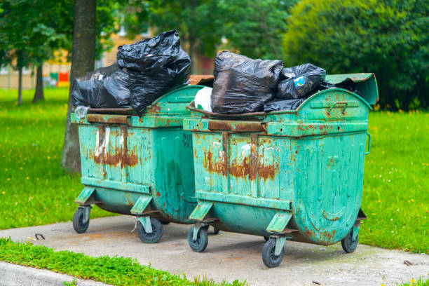 istock dumpsters on wheels old green rusty full of garbage packages 1167658513