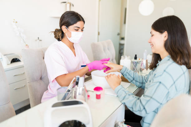 istock Cosmetician Scrubbing Customer's Hand In Spa 1167659404