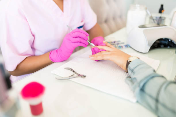 istock Manicurist Working Over Client's Nails In Salon 1167659420