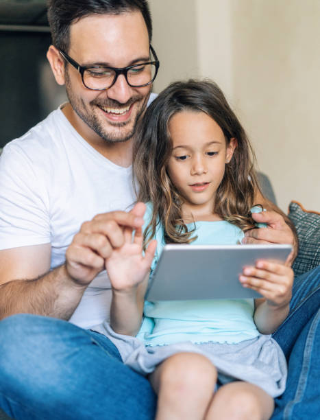 istock Father and daughter looking at digital tablet 1167663702