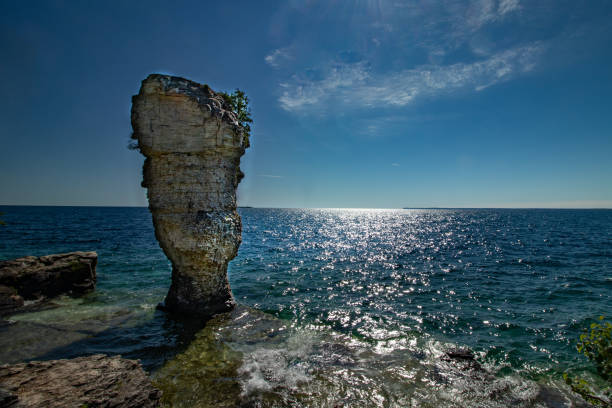 istock Thin clouds dot the afternoon sky over flowerpot island, Lake Huron, ON 1167664097