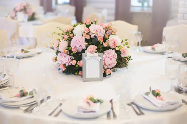 Photo of Guest table, with bouquet from petals and a number.wedding concept