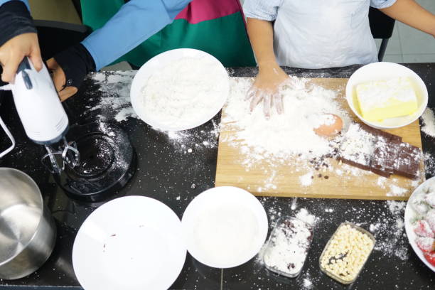 istock Close up Hand playing with flour eggs, kids cute girl having fun making cake, messy kitchen. 1167667362
