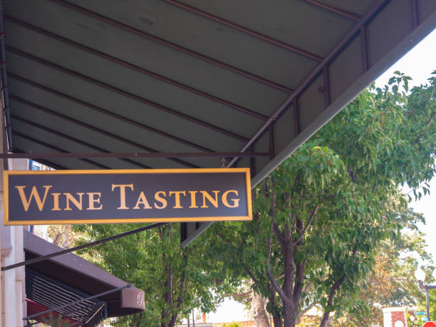 istock Wine Tasting Sign Hanging In Front Of Downtown Shops 1167667378