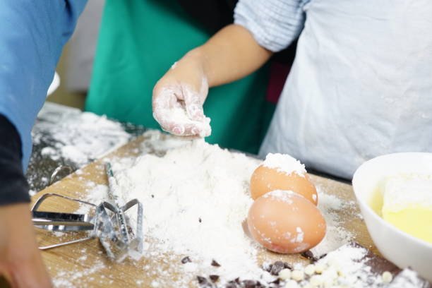 istock Close up Hand playing with flour eggs, kids cute girl having fun making cake, messy kitchen. 1167667382