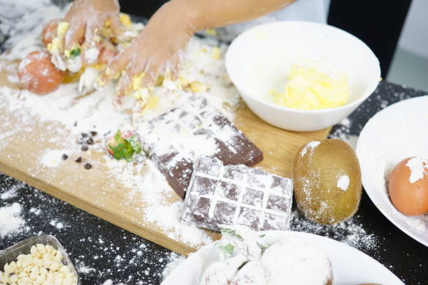 Close up Hand playing with flour eggs, kids cute girl having fun making cake, messy kitchen.
