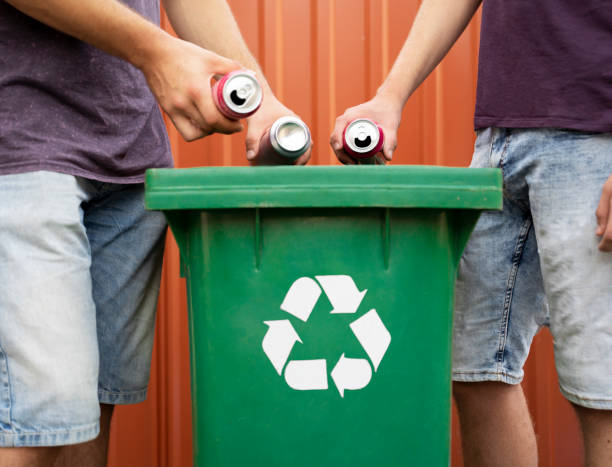 istock Men putting tin cans in recycle bin 1167668069