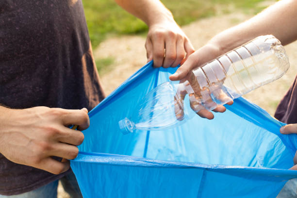 istock Closeup man putting plastic bottle in the bag recycle 1167668071
