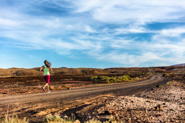 istock Trail runner woman athlete running fast in lanscape 1167672742